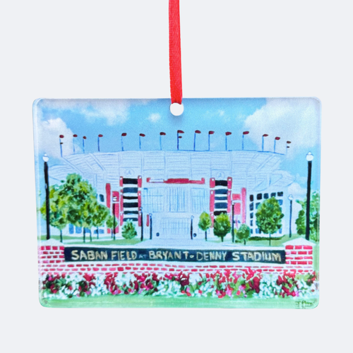 Saban field at bryant denny stadium christmas tree ornament. Features the iconic football stadium at the University of  Alabama. Roll Tide. It has shades of green, white, gray, black, gold and blue. It  is rectangular and comes with a red ribbon for displaying.