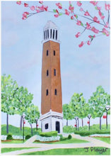 Load image into Gallery viewer, Denny Chimes Acrylic Block Art. This Alabama Crimson Tide free standing acrylic block art is vertical and features the famous Bell Tower landmark that is in The Quad at The University of Alabama. This is a print on an acrylic block of a bell tower with flowering trees and plants. Roll Tide!
