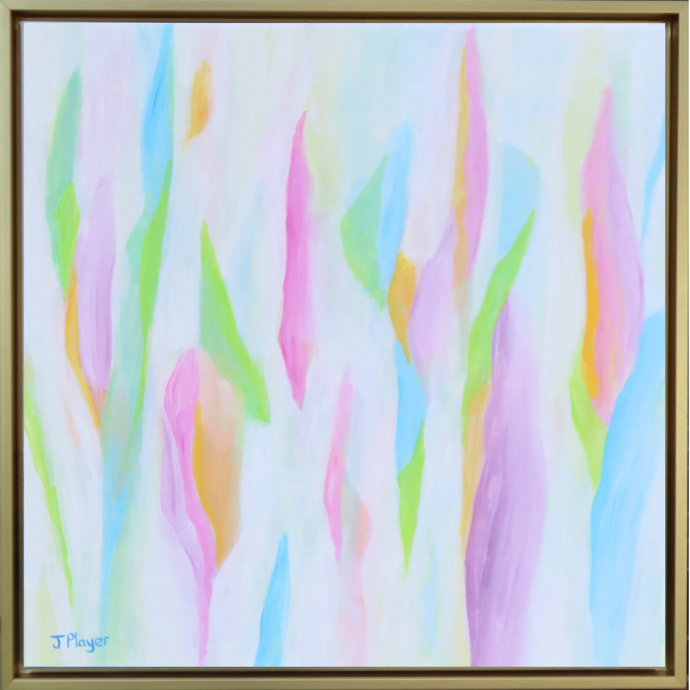 The Colors of Summer is a colorful abstract painting on a gallery wrapped canvas. It has bright and happy shades of purple, blue, green, pink and orange on a white background. This medium size square painting measures 24 x 24 inches and is in a gold float frame. The shapes almost resemble tulips and seem to have a vertical nature. 