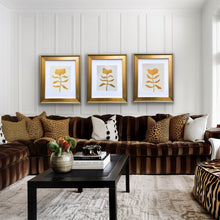 Load image into Gallery viewer, Three original gold flower paintings styled over a brown sofa in a beautiful room
