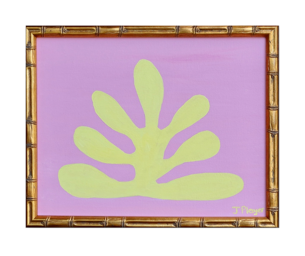 This is a bold and preppy seaweed art design on a canvas. This painting has a yellow seaweed shape on a pink background. This is a horizontal painting in a gold bamboo frame.