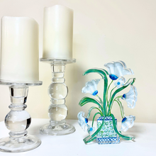 Load image into Gallery viewer, Belle Fleurs acrylic shelf sitter styled on a bookcase with whimsical floral artwork in shades of blue, aqua, pink, and white.

