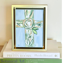 Load image into Gallery viewer, Contemporary Christian wall art featuring expressive blue and green floral cross on canvas. Faith inspired floral cross painting with textured acrylic details and elegant gold float frame
