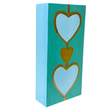 Load image into Gallery viewer, Modern coastal artwork on wood panel with layered heart motifs and vibrant turquoise background.
Contemporary heart decor ideal for beach homes, feminine interiors, and colorful shelf styling.
