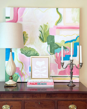 Load image into Gallery viewer, Modern and colorful pink flower art styled with abstract art, books, and candlesticks on a wood chest.
