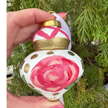 Load image into Gallery viewer, Grandmillennial-inspired hand-painted ornament showcasing whimsical pink florals, gold accents, and elegant holiday styling.
