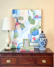 Load image into Gallery viewer, Decorative setup with a lamp, books, and a vase on a wood table against a colorful abstract painting and a chinoiserie vase.
