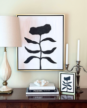 Load image into Gallery viewer, Decorative setup with a black and white floral art piece, candles, and books on a table. For a elegant traditional interior.
