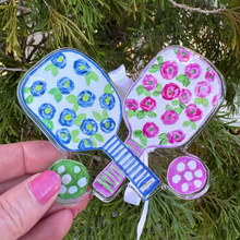 Load image into Gallery viewer, Front view of a pickleball-themed ornament featuring colorful pickleball-inspired artwork
