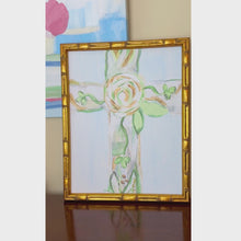 Load and play video in Gallery viewer, A fine art giclee print with a green, white, gold and gray floral cross on a light blue background. Displayed in a gold bamboo frame.
