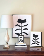 Load image into Gallery viewer, Monochromatic black and white floral paimtings on a traditional wood table.
